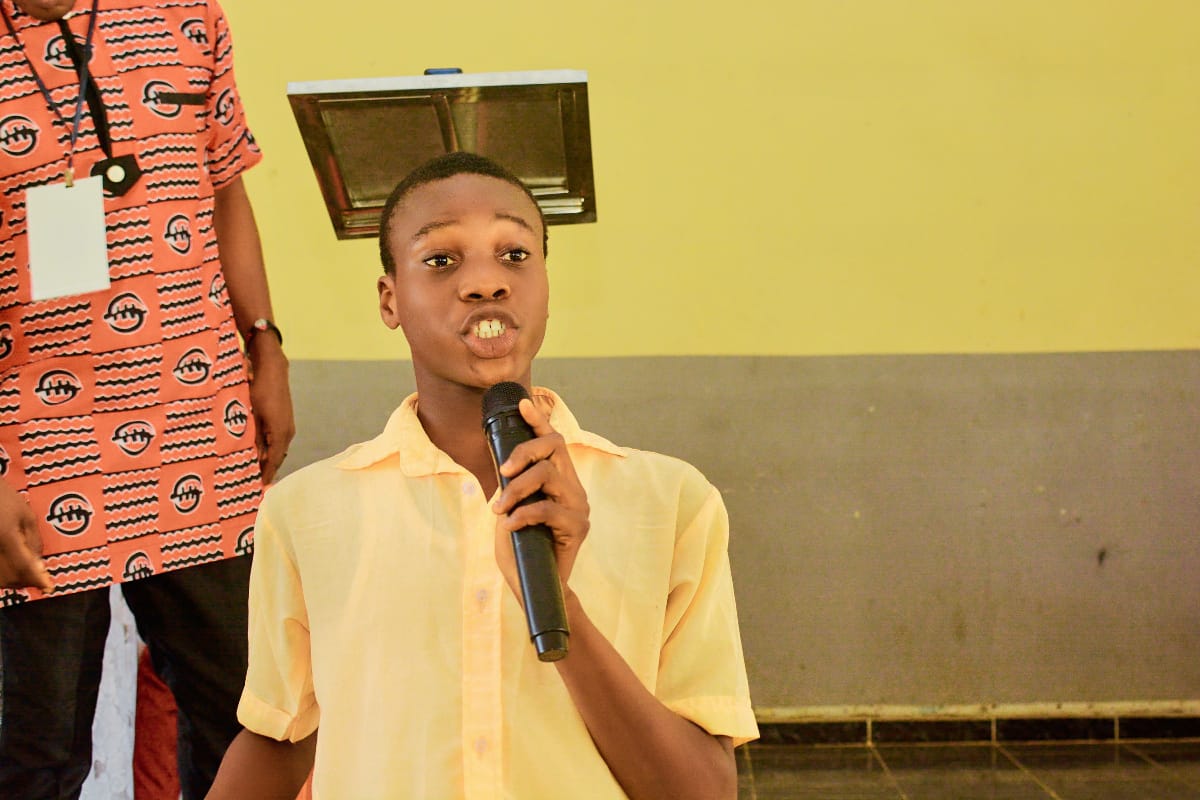 Woman in traditional attire with event credentials